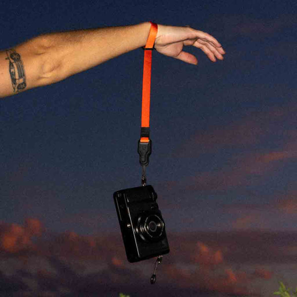 Strength Demonstration of the WANDRD Magnetic Camera Wrist Strap Red