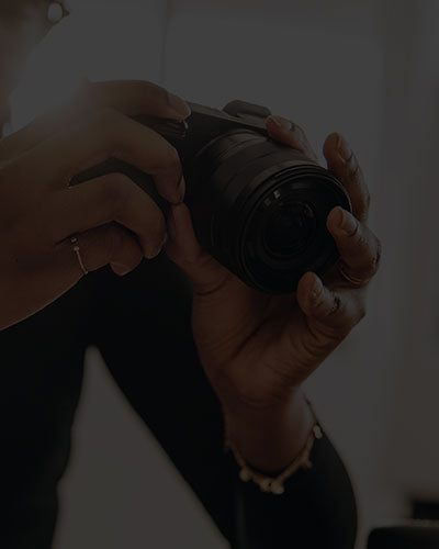 hands holding a camera