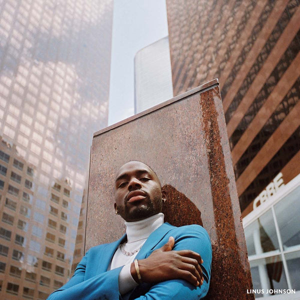 man leaning against a pillar