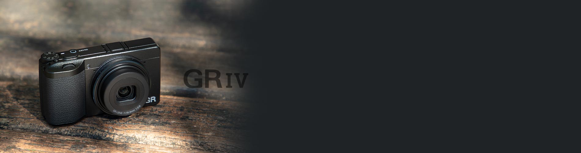 Black camera with 'GR IV' branding on a textured surface