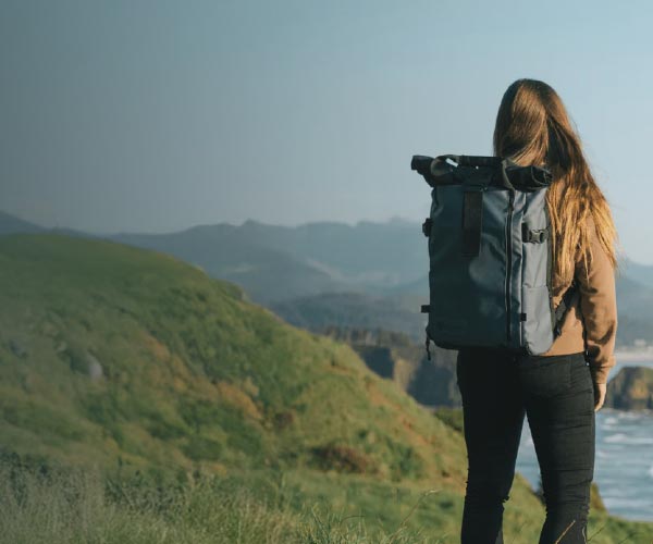 Female photographer carrying a Wandrd PRVKE Bag on her back