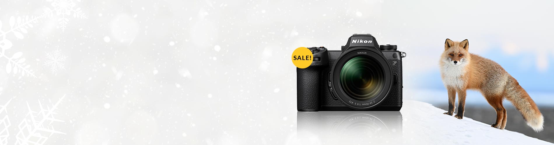 Camera with a 'Sale' tag next to a fox on a gradient background